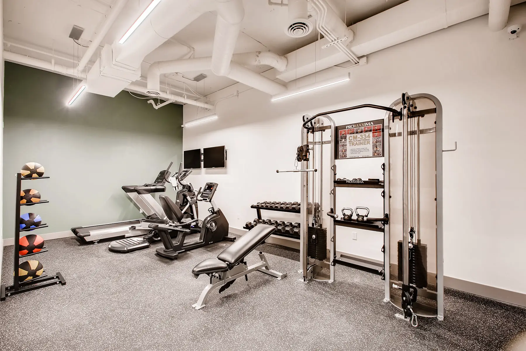 Fitness center with cario equipment, free weights, and multi cable station
