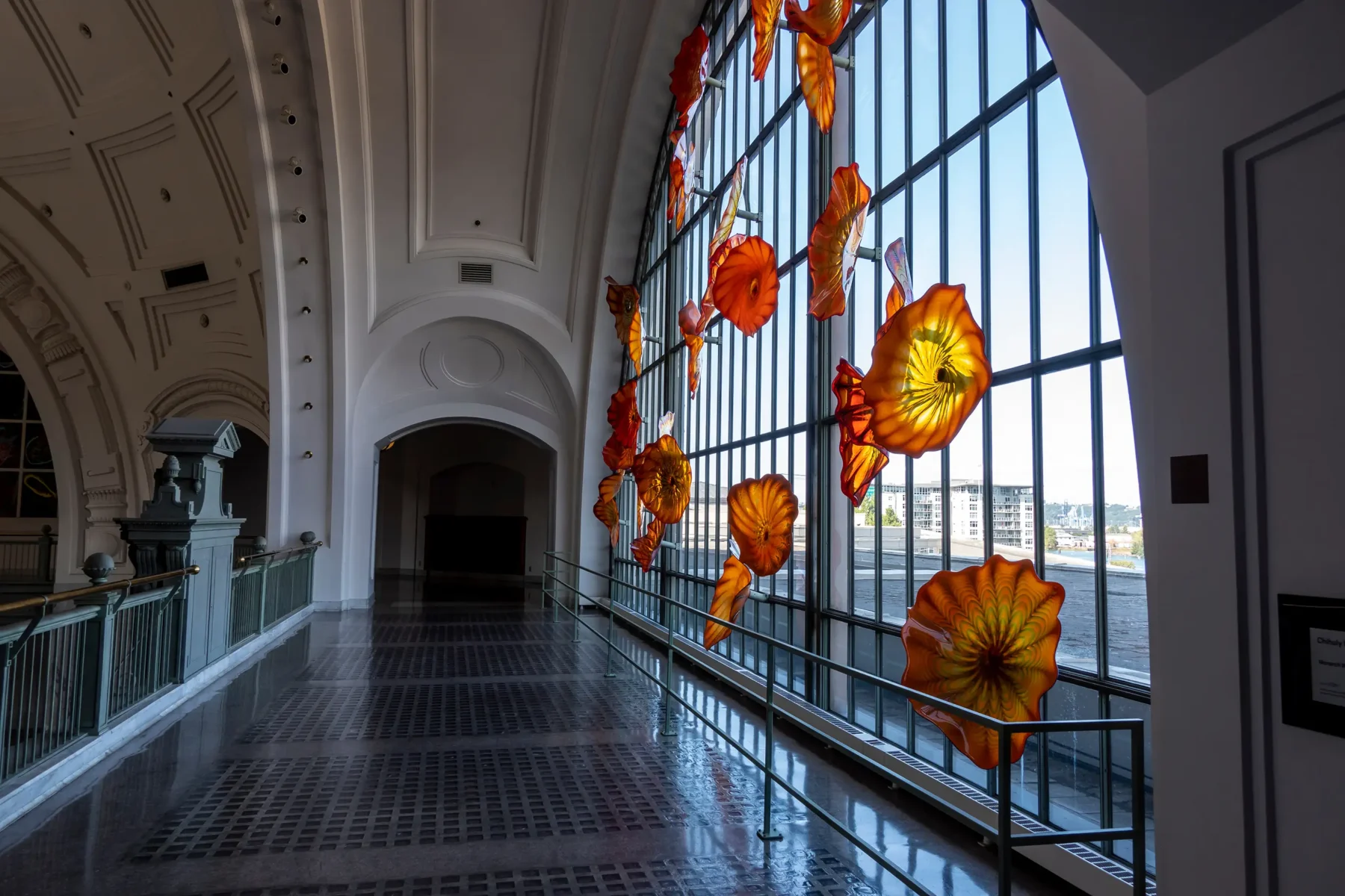 Stained glass art exhibit, large abstract glass flowers hanging in a large window