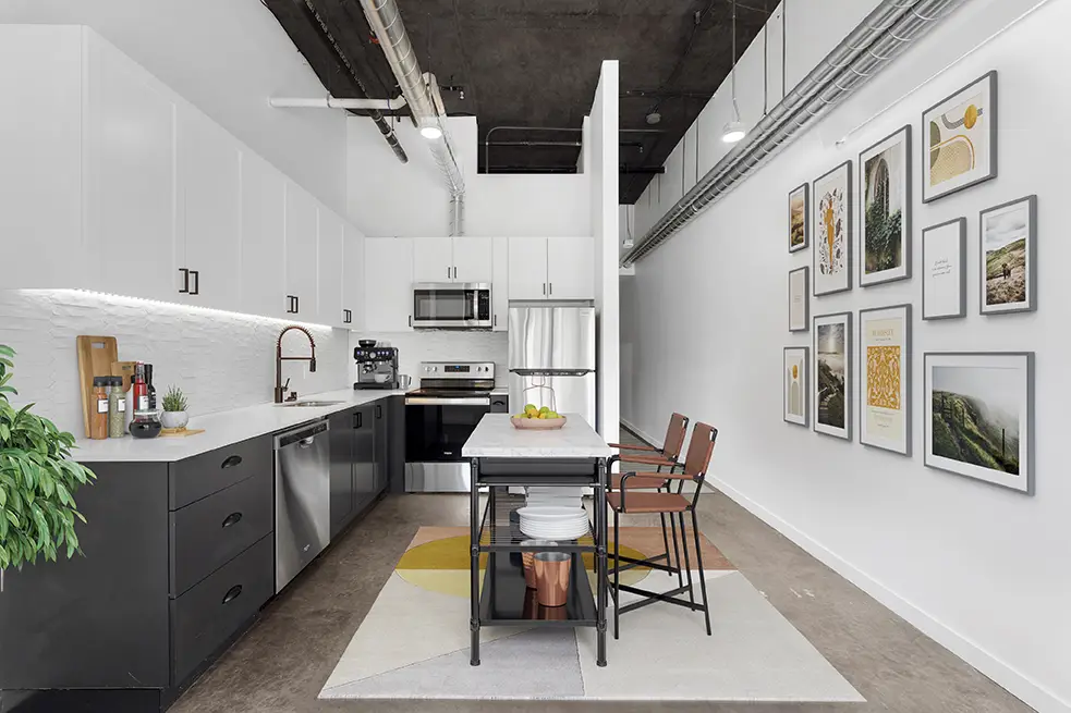 Modern kitchen with stainless steel appliances, tile backsplash, and under cabinet lighting
