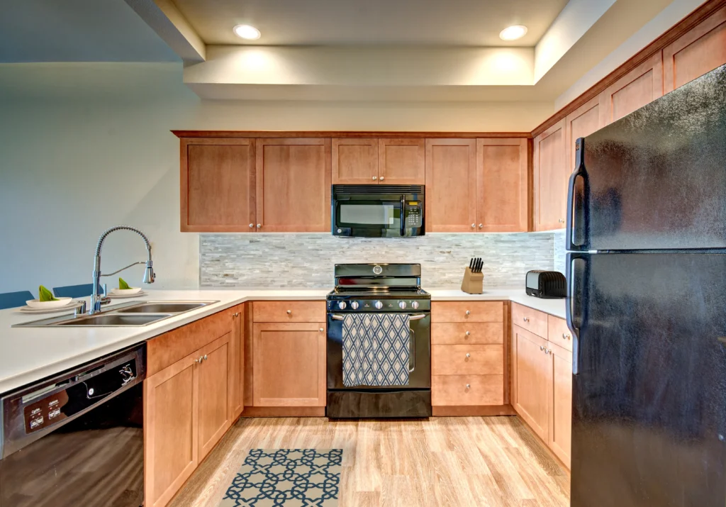 Kitchen with black appliances, tile backsplash